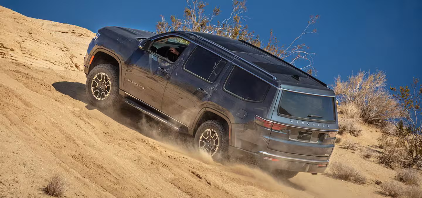 A suv driving up a hill.