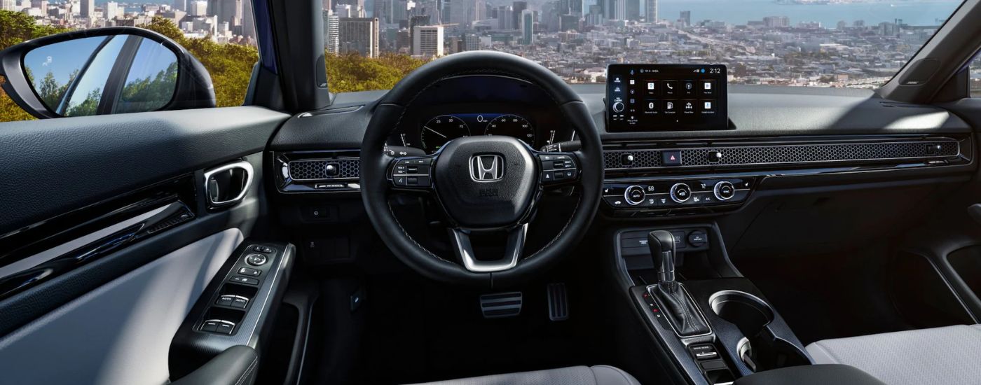 The steering wheel, dashboard and infotainment display on a 2026 Honda Civic.