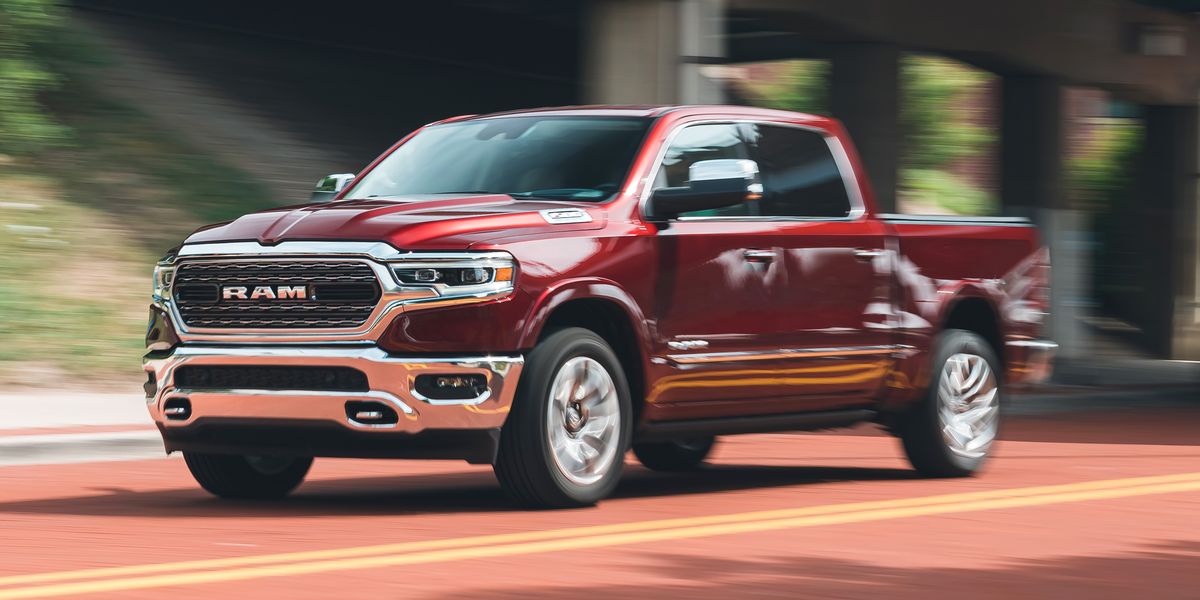 a red ram 1500 in a blurry action shot driving under a highway bypass