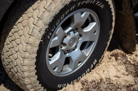 Close up on dirty Toyota offroad truck tire.