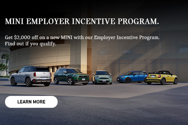 MINI fleet parked in front of a parking structure.