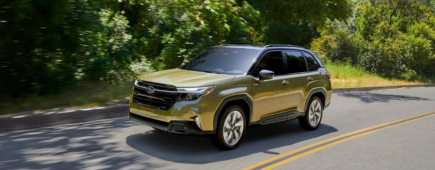 A green 2025 Subaru Forester driving.