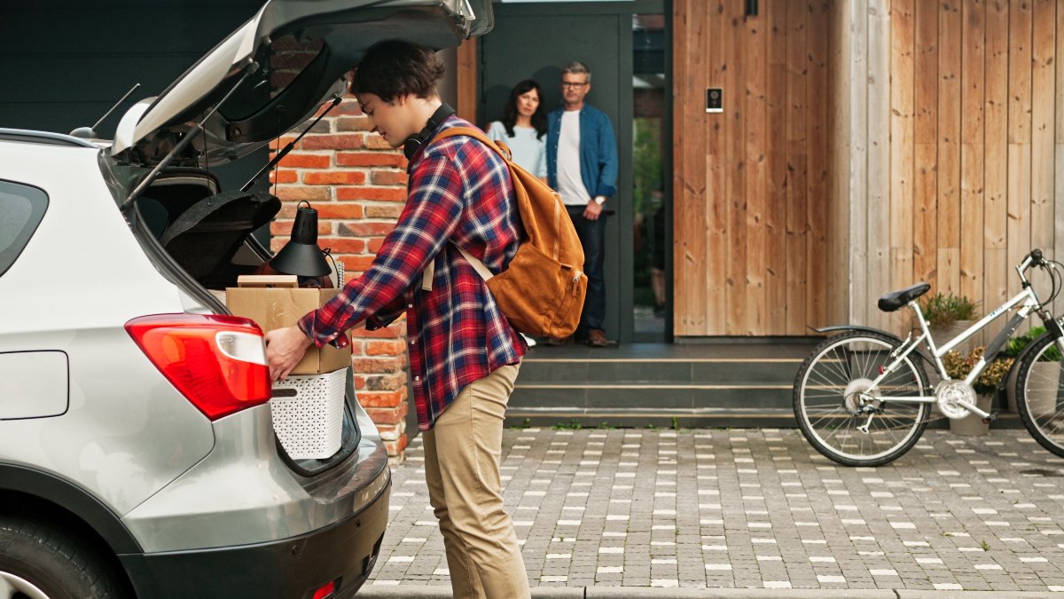 College Student Loading His Car with Parents in Background