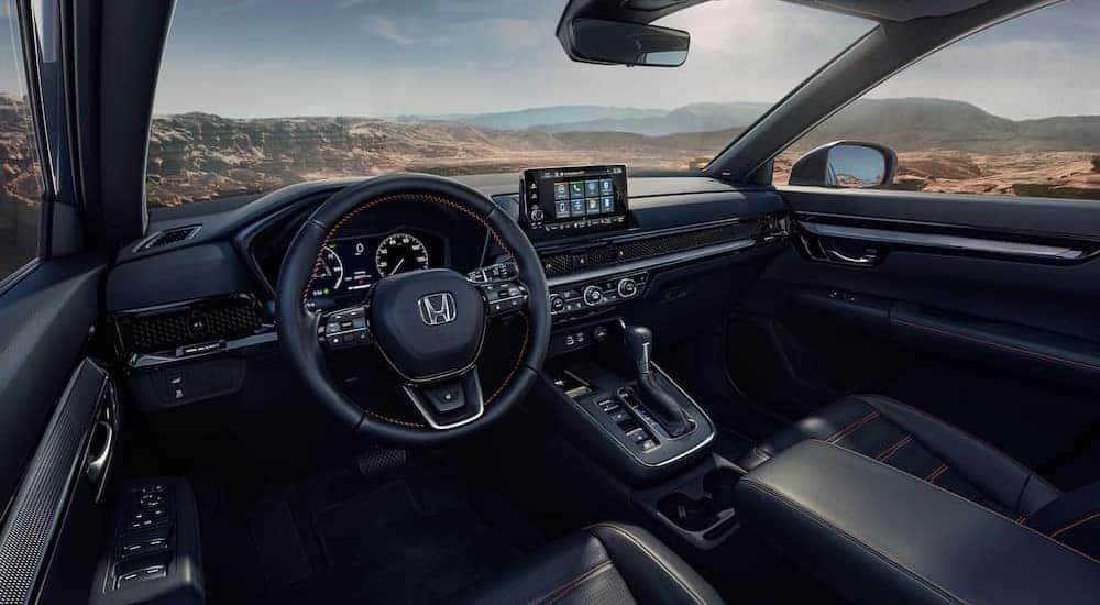 The black interior and dash of a 2023 Honda CR-V is shown.