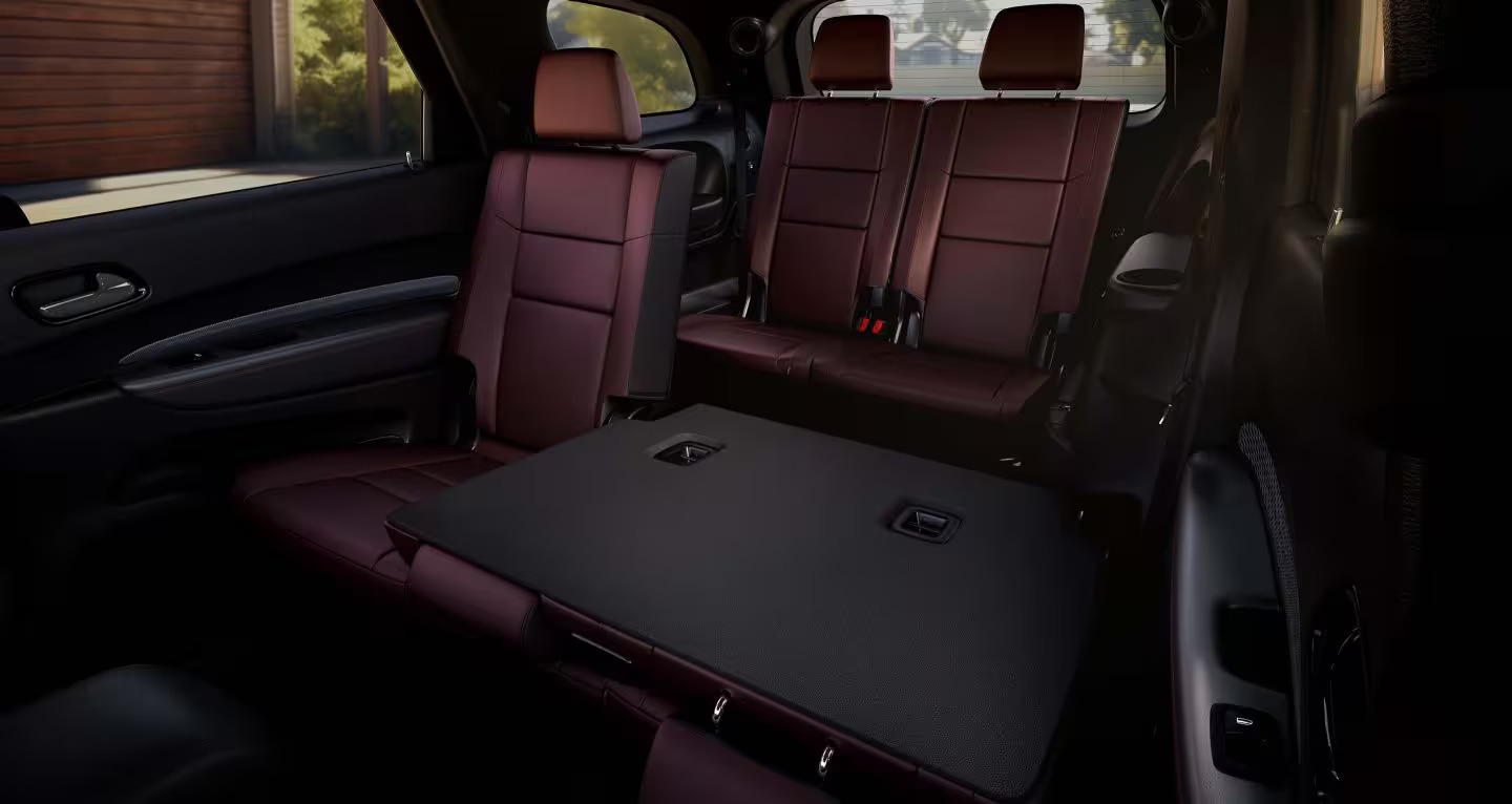 The interior of a suv with a seat down.