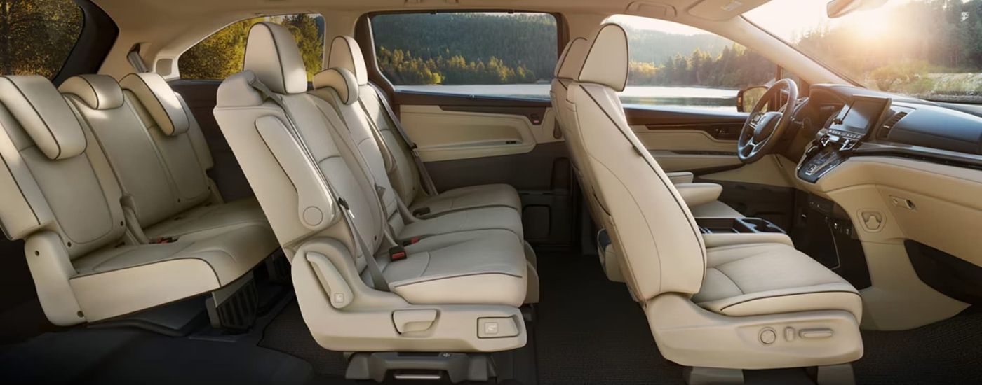 Tan interior and seats are shown from the side on a 2021 Honda Odyssey