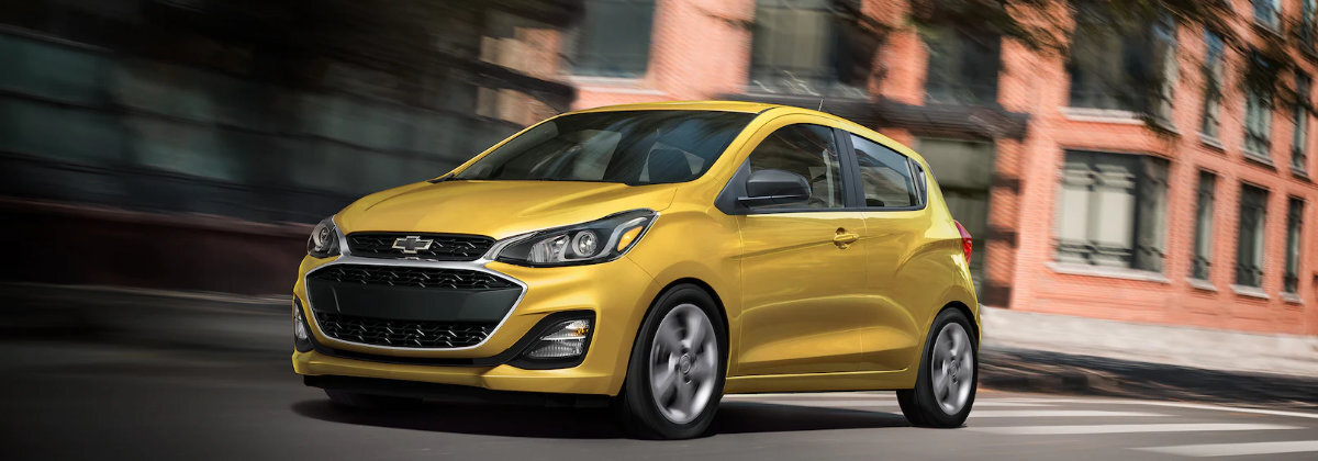 A yellow 2022 Chevrolet Spark driving. 