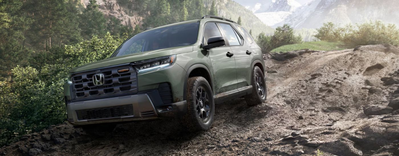 Green 2026 Honda Pilot Trail Sport driving off-road.