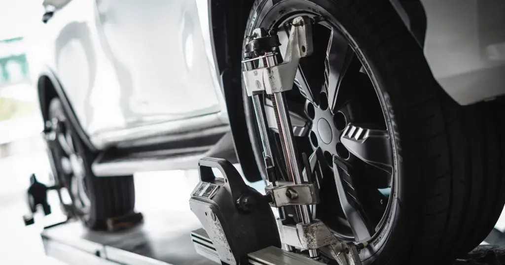 Close-up of car tire undergoing service