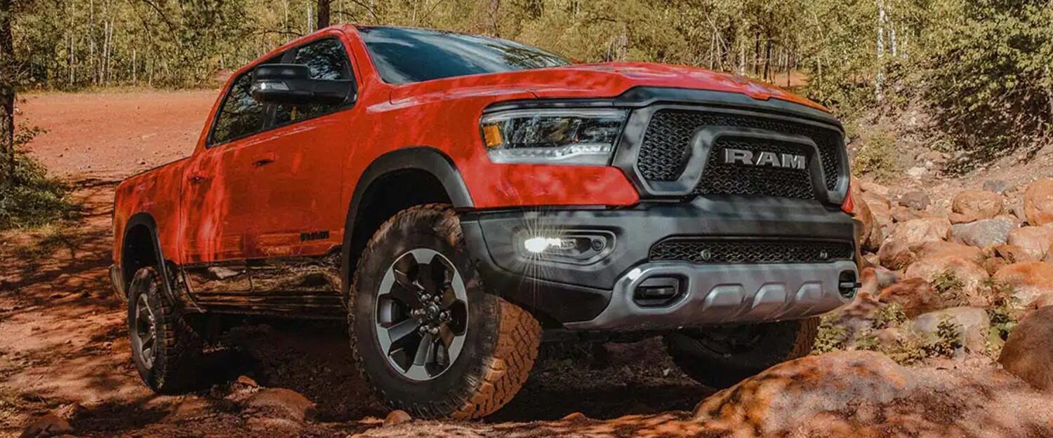 A red ram 1500 parked on a hill.