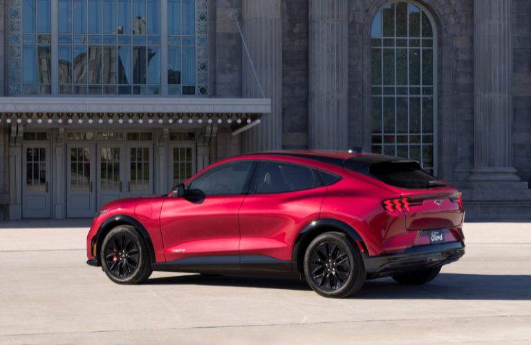 Red 2025 Ford Mustang Mach-E Rear Exterior in Front of Brick Building