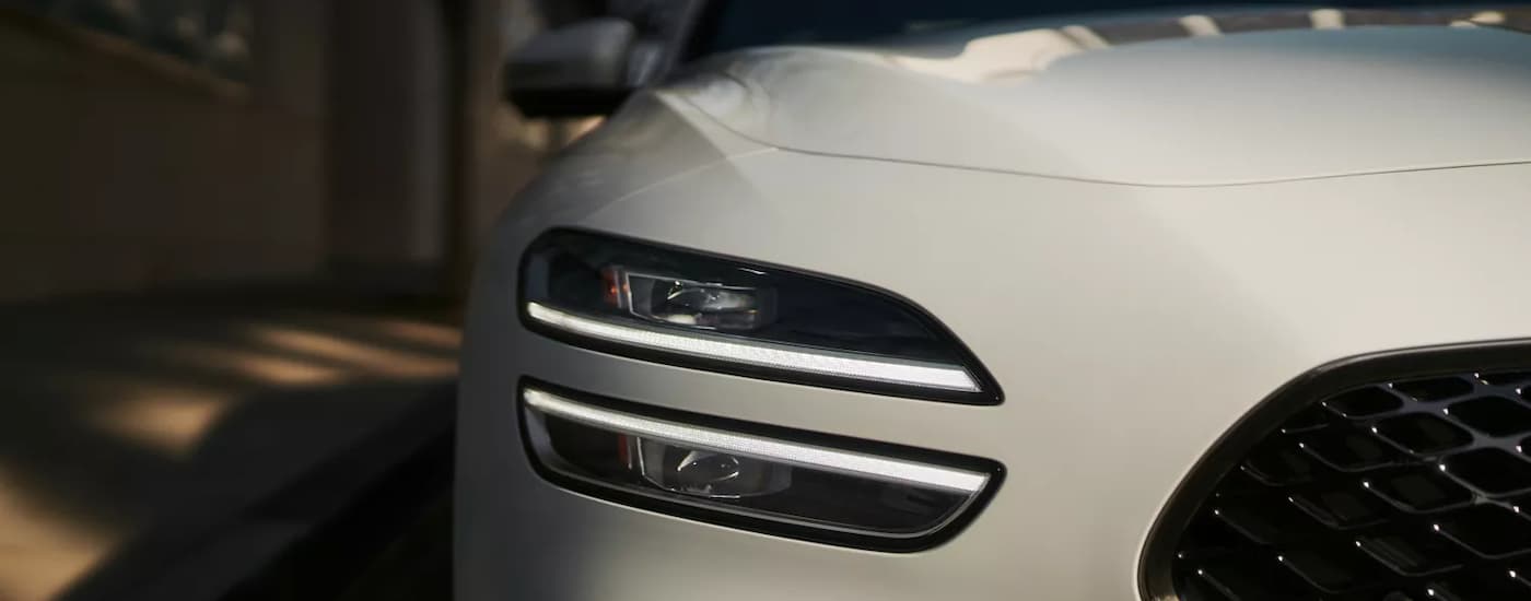 Headlight and grille on a white 2026 Genesis G70