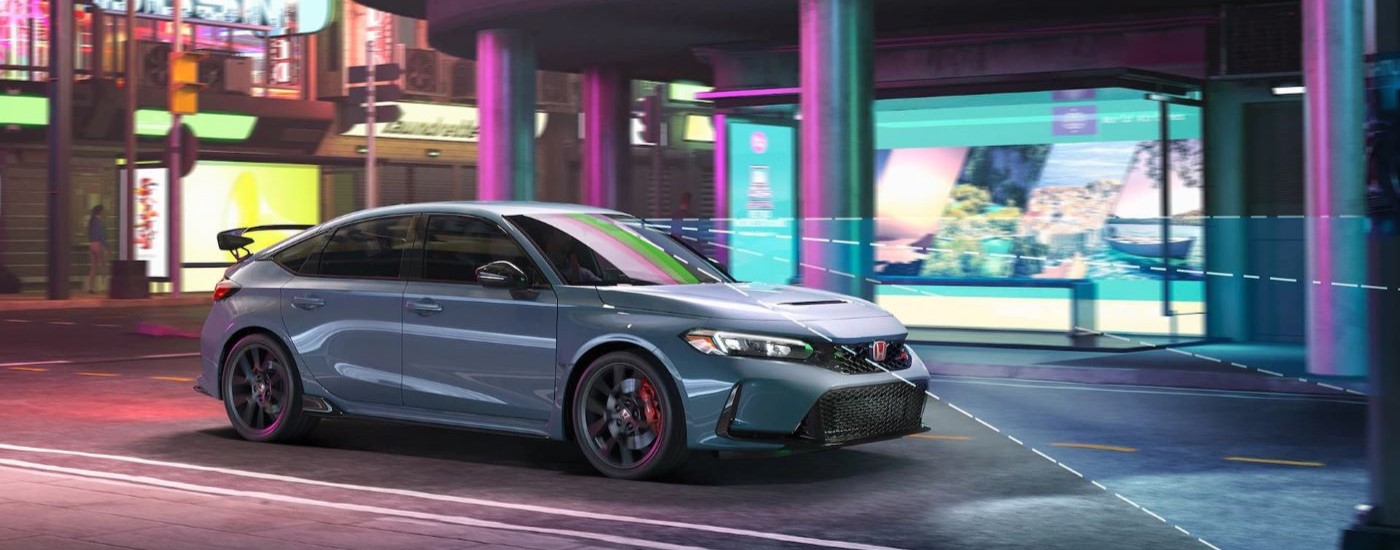 Blue 2023 Honda Civic Type R on a city street at night