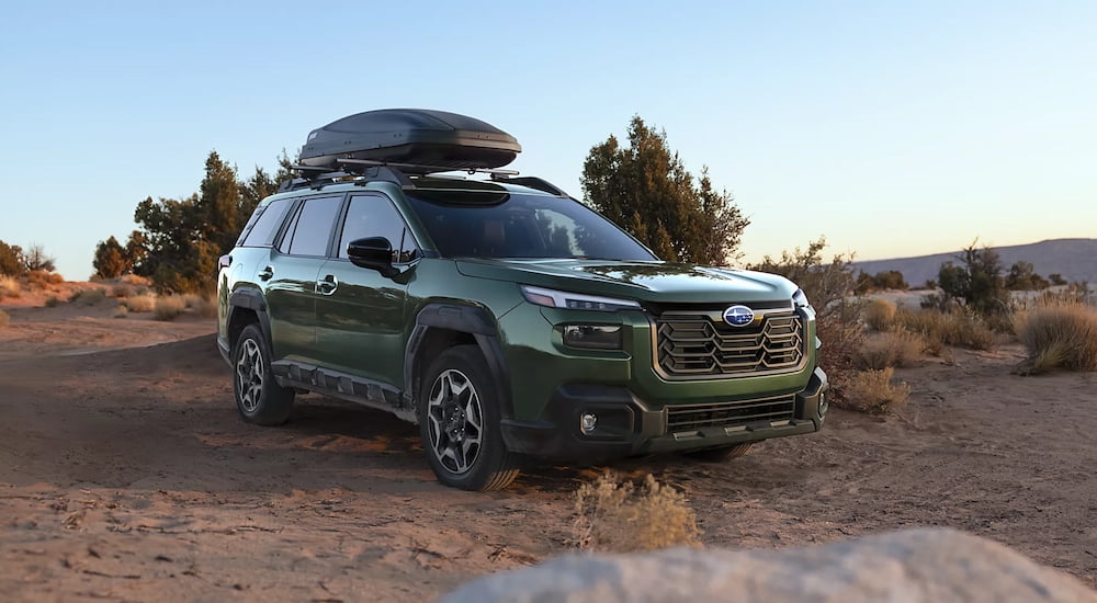Dark green 2026 Subaru Outback parked off-road.