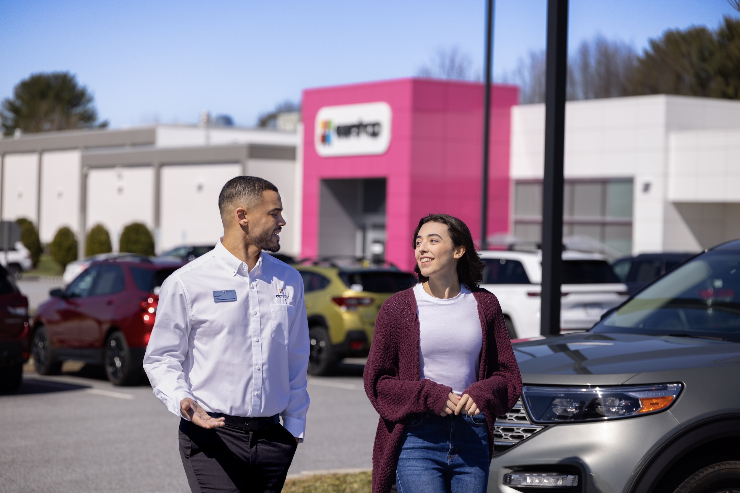 Associate walking with client through lot. 