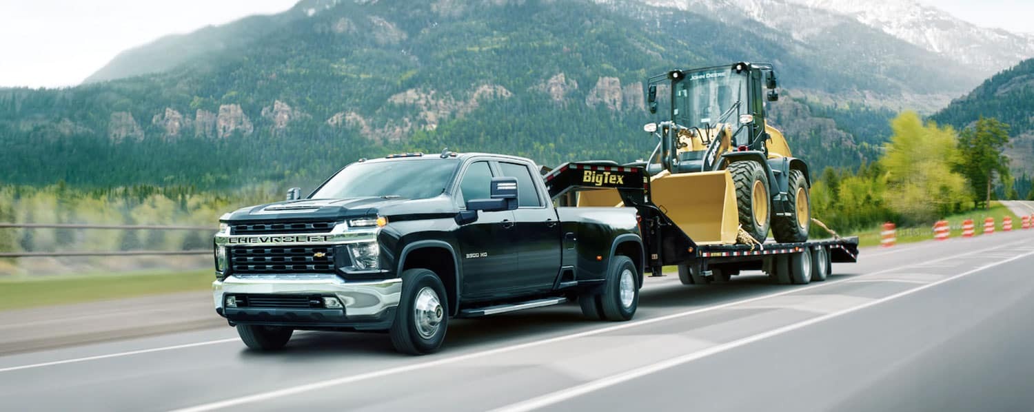 The 2021 silverado 3500 hd pulling a bulldozer.