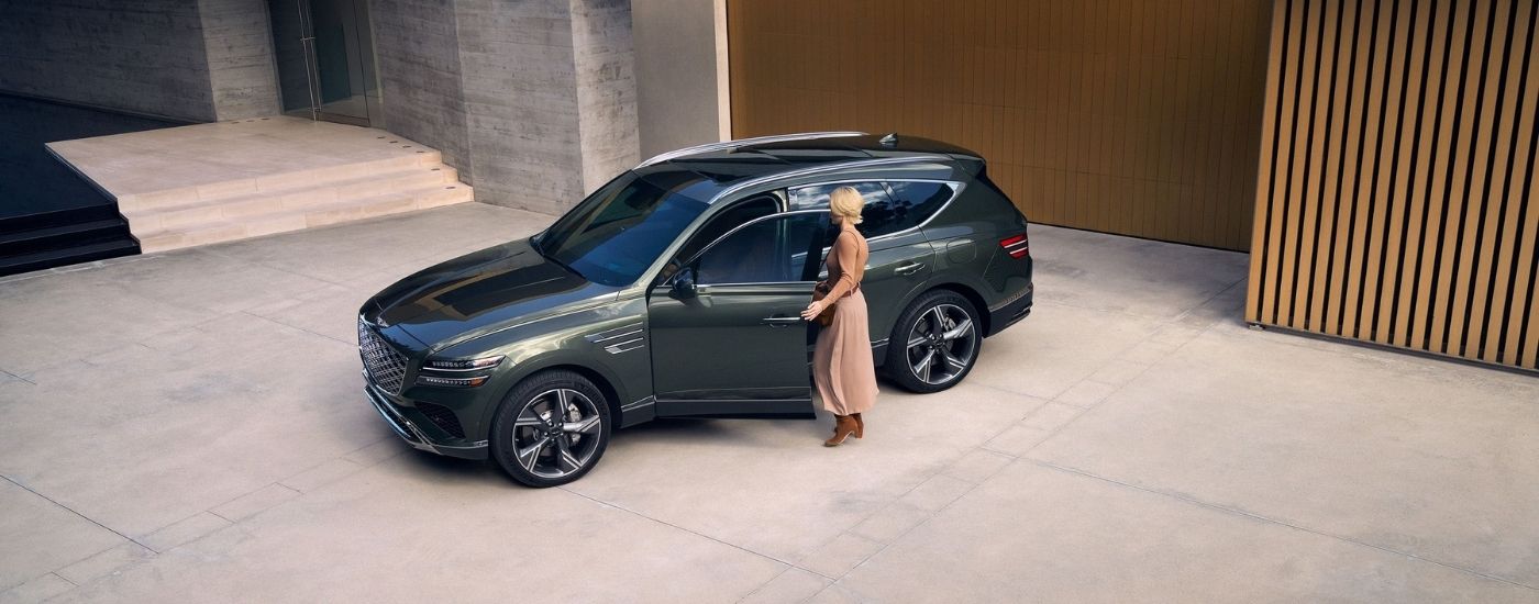 Aerial view of a green 2025 Genesis GV80 parked on a driveway