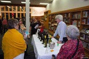 Guests at a wine tasting in the library