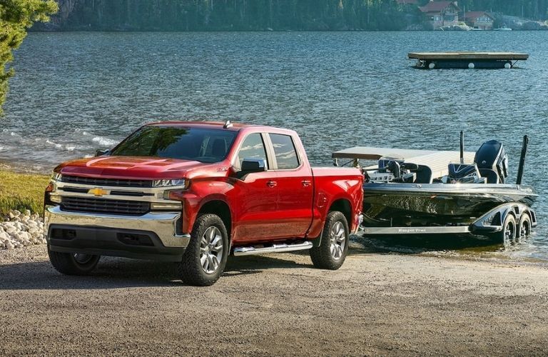 Red 2021 Chevy Silverado Towing a Boat