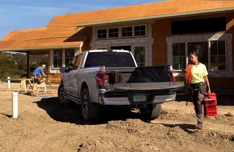 Silver 2022 Ford F-150 Lighting Rear Exterior on a Jobsite