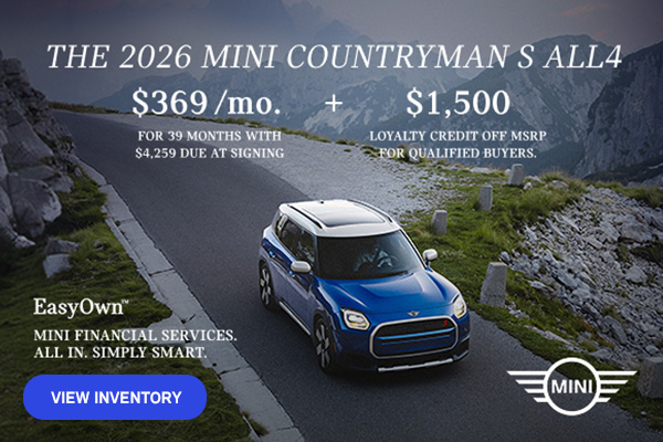 Front view of a blue MINI Countryman  driving on a mountainous road.
