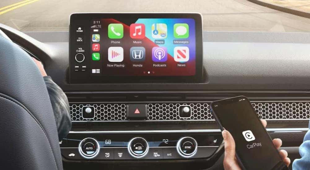 A close-up of the infotainment screen is shown in a 2025 Honda Civic Hatchback.