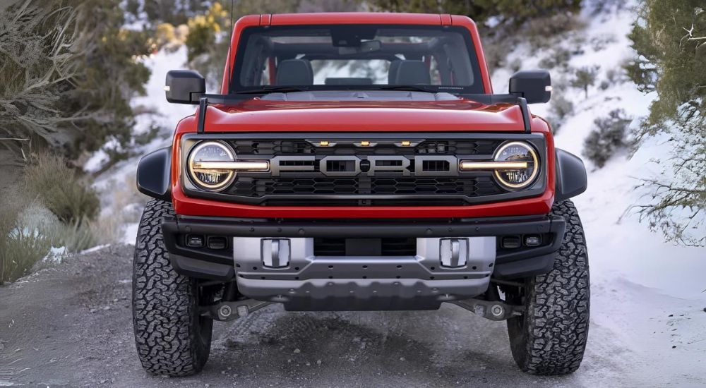A red 2023 Ford Bronco Raptor front grille view.