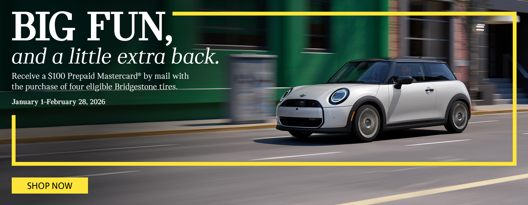 White MINI 2 Door driving down the street.