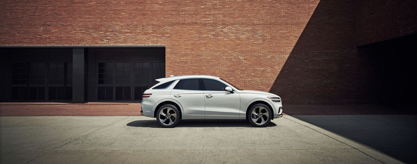 White 2026 Genesis GV70 for sale near Prattville parked near a brick wall