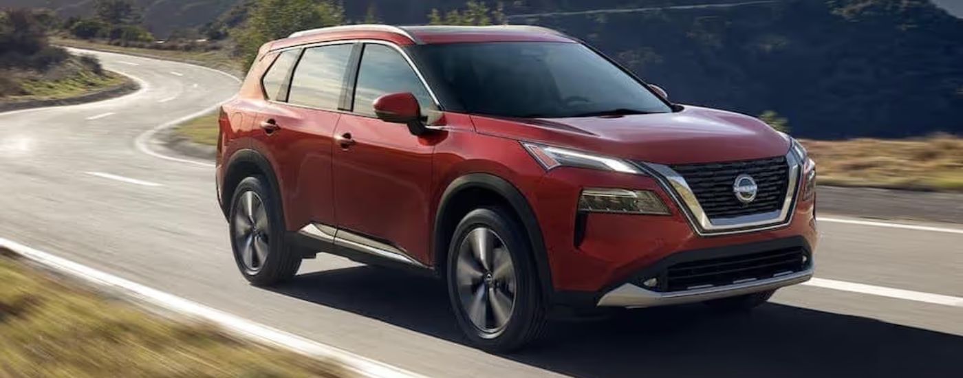 A red 2023 Nissan Rogue is shown from the front at an angle.