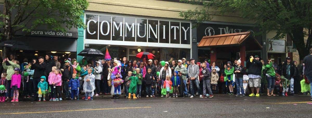Crowd in costumes outside a community building at a festival