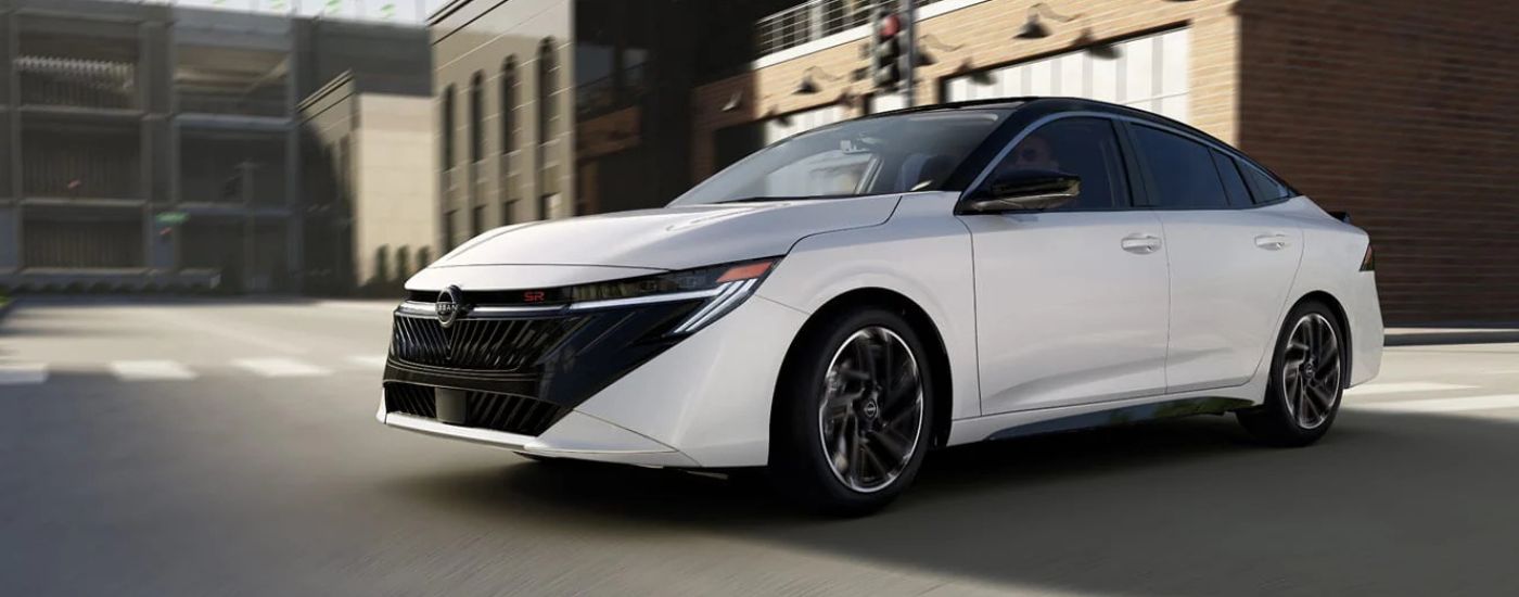 White 2026 Nissan Sentra turning through an intersection.