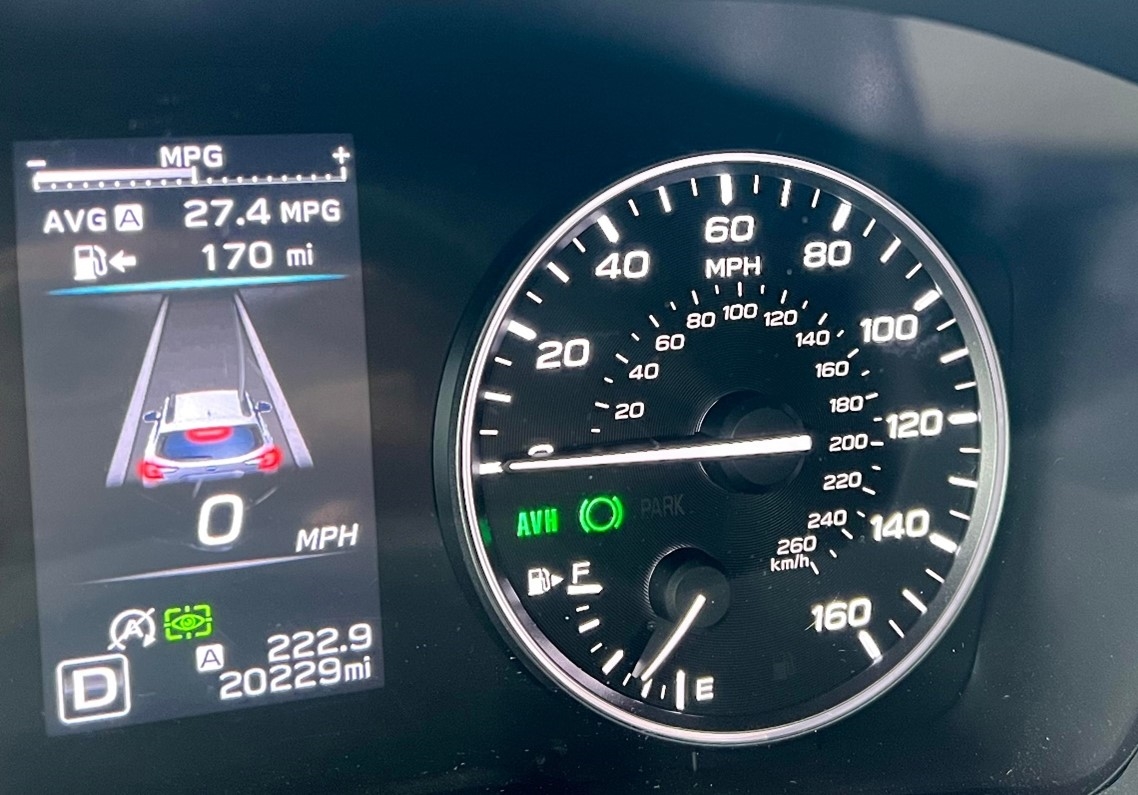 A close-up on the speedometer inside a Subaru vehicle with Auto Vehicle Hold activated.