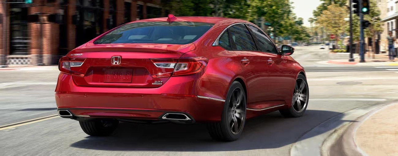 Red 2021 Honda Accord Touring driving on a city street