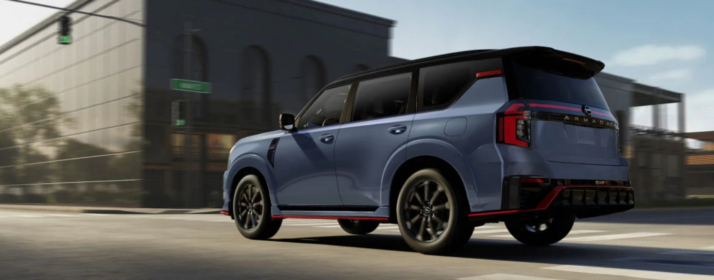Grey 2026 Nissan Armada Nismo driving through an intersection