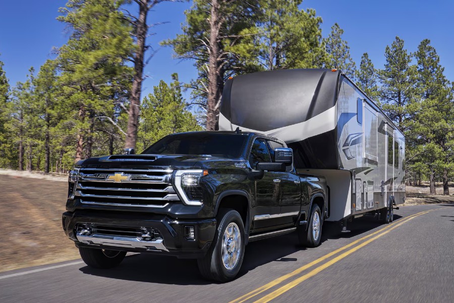 2026 Chevy Silverado HD Exterior Driver Side Front Angle while Towing a Camper