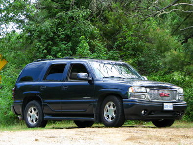 Black GMC Yukon Denali parked offroad.