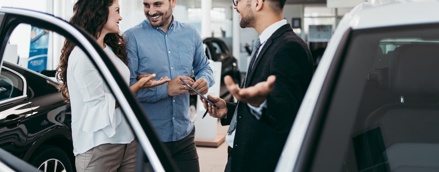 A salesman is shown standing in a certified pre-owned Honda dealer.
