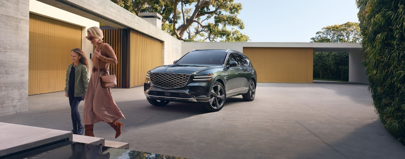 Green 2025 Genesis GV80 for sale near Pike Road parked in front of a home after a test drive
