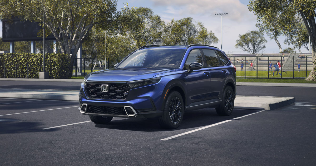 A blue Honda CR-V parked at a soccer field.