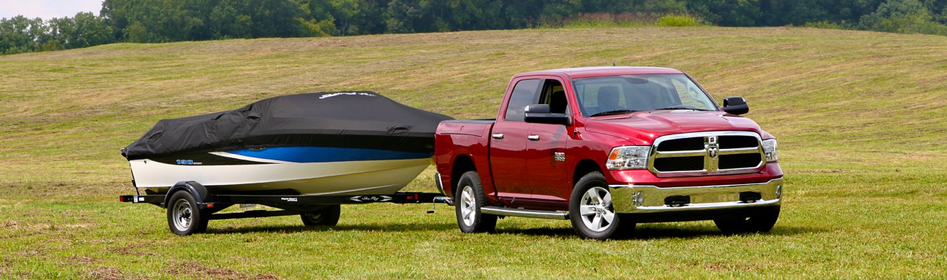 2013 RAM 1500 Exterior Passenger Side Front Profile while Towing a Boat