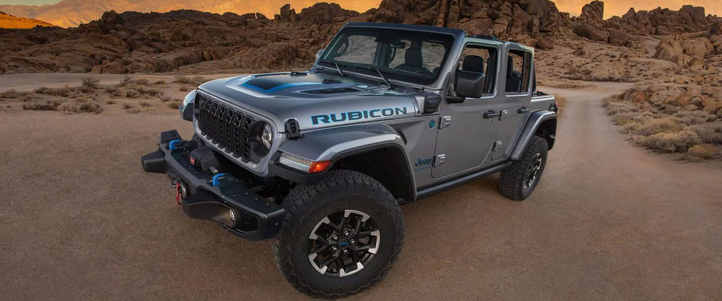 an suv parked in the desert at dusk. 