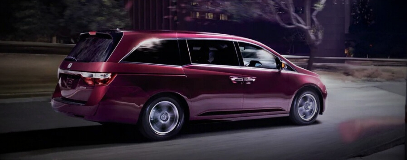 Maroon 2011 Honda Odyssey Elite driving at night