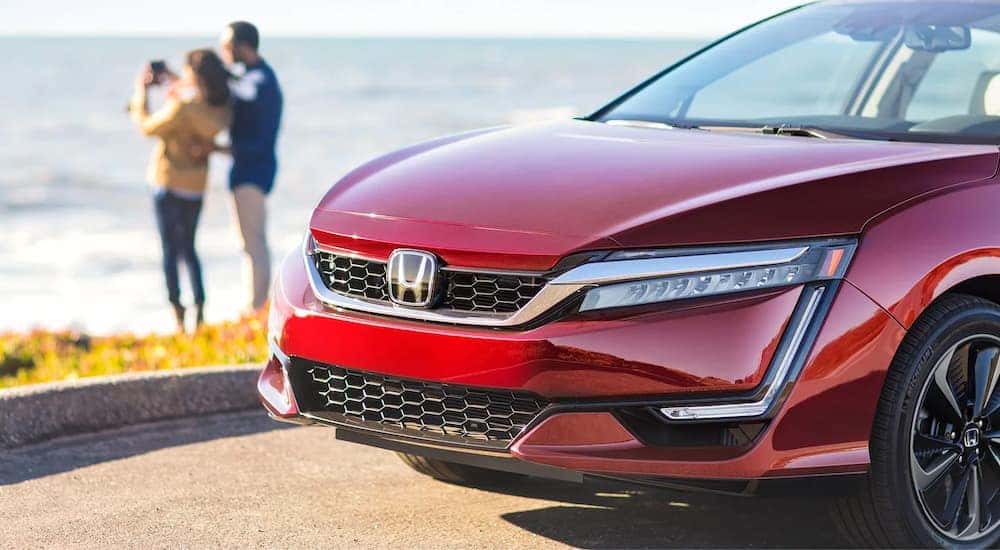 A red 2022 Honda Clarity is shown parked near a body of water