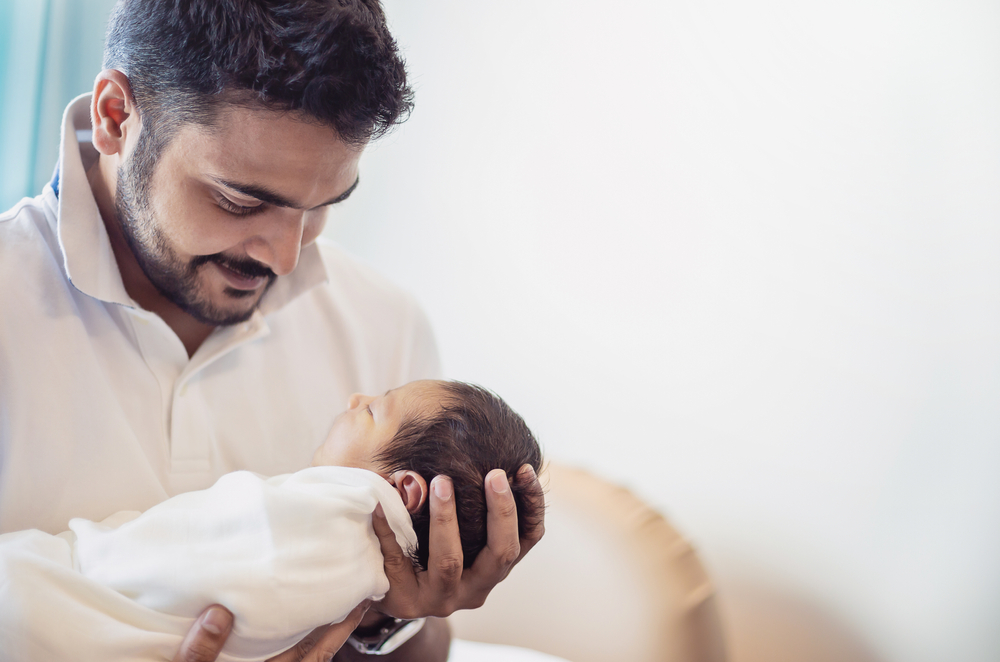 father holding newborn baby