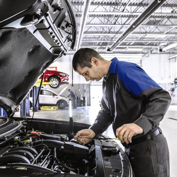 image of ford service employee inspecting vehicle