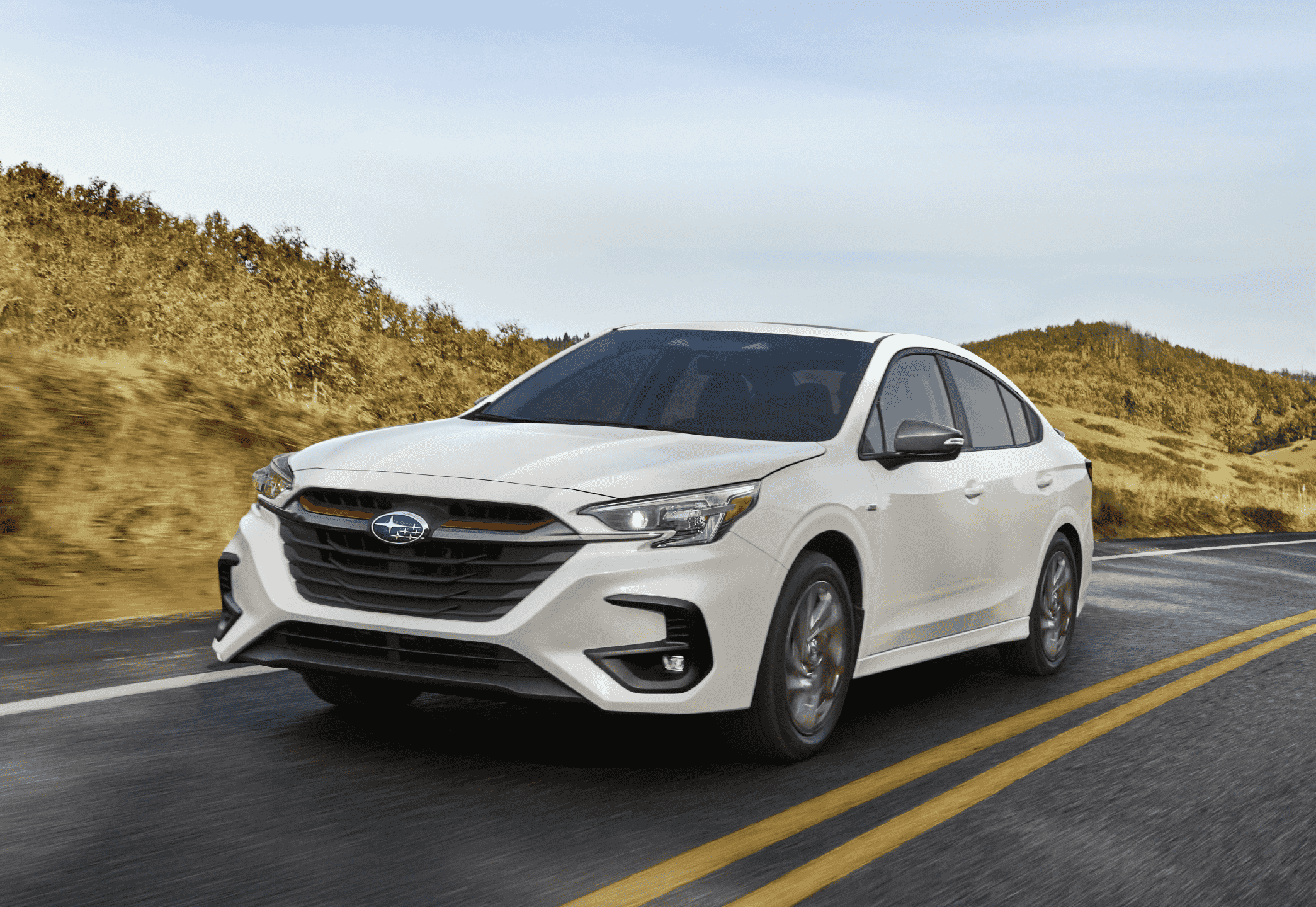 White Subaru driving on road in desert