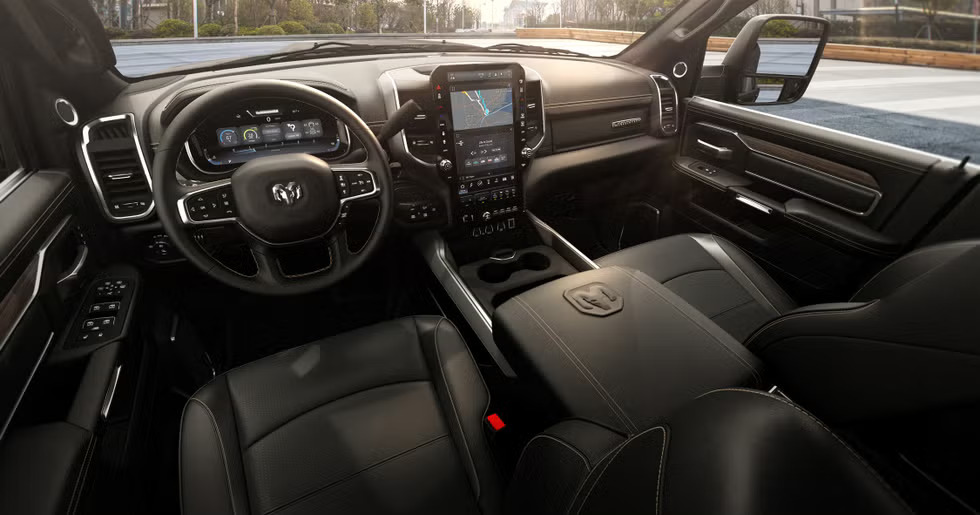 The black leather interior with white stitching and a large infotainment screen of a 2025 RAM 2500.