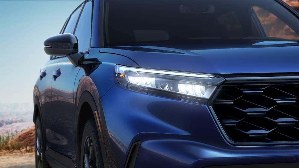 Close-up of a headlight on a blue 2026 Honda CR-V.