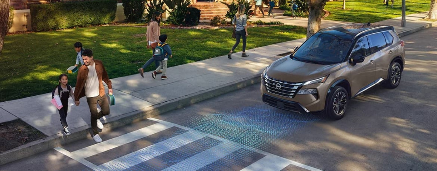 Grey 2024 Nissan Rogue at an intersection